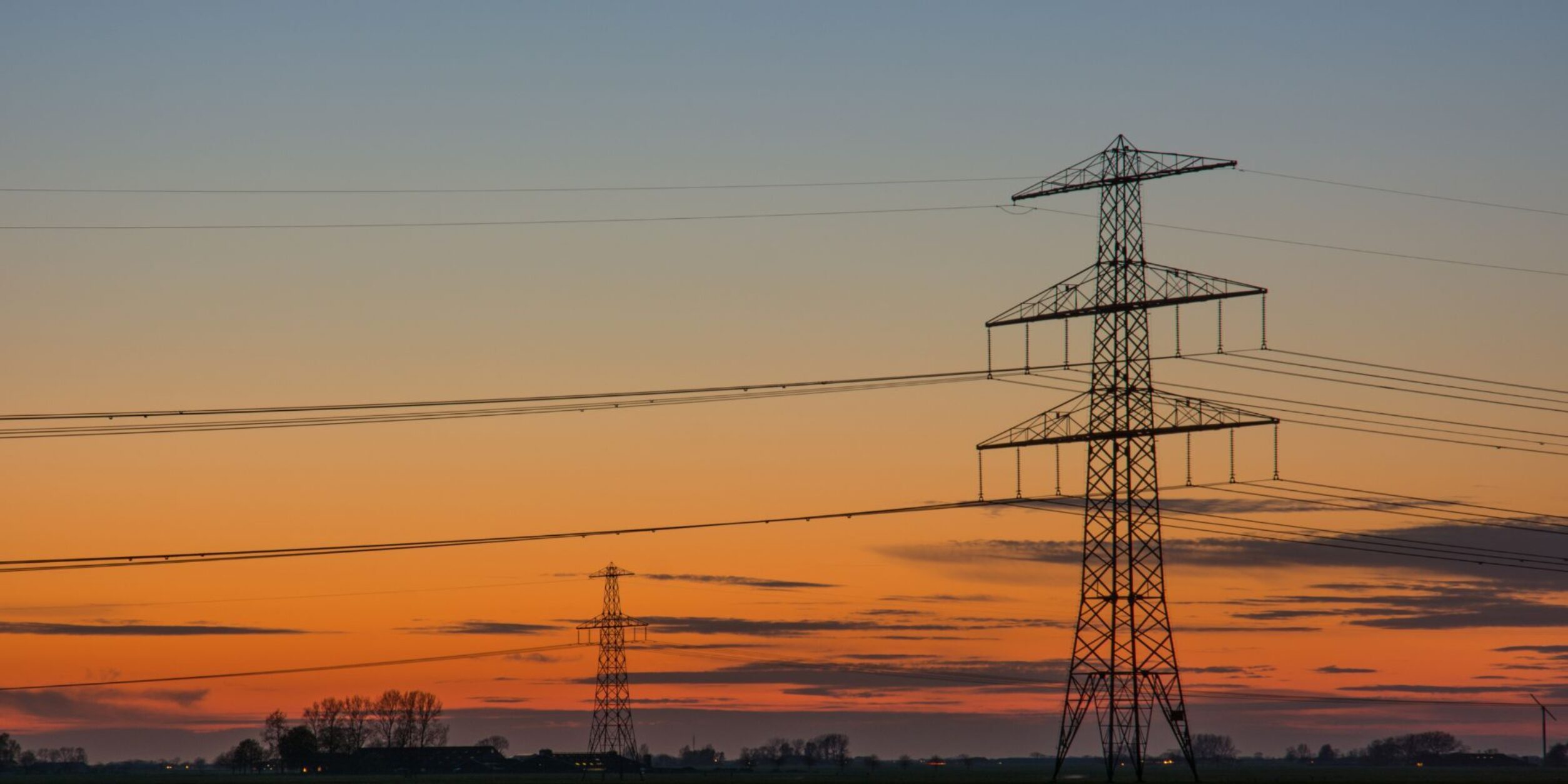 Freileitungsmasten in der Abenddämmerung