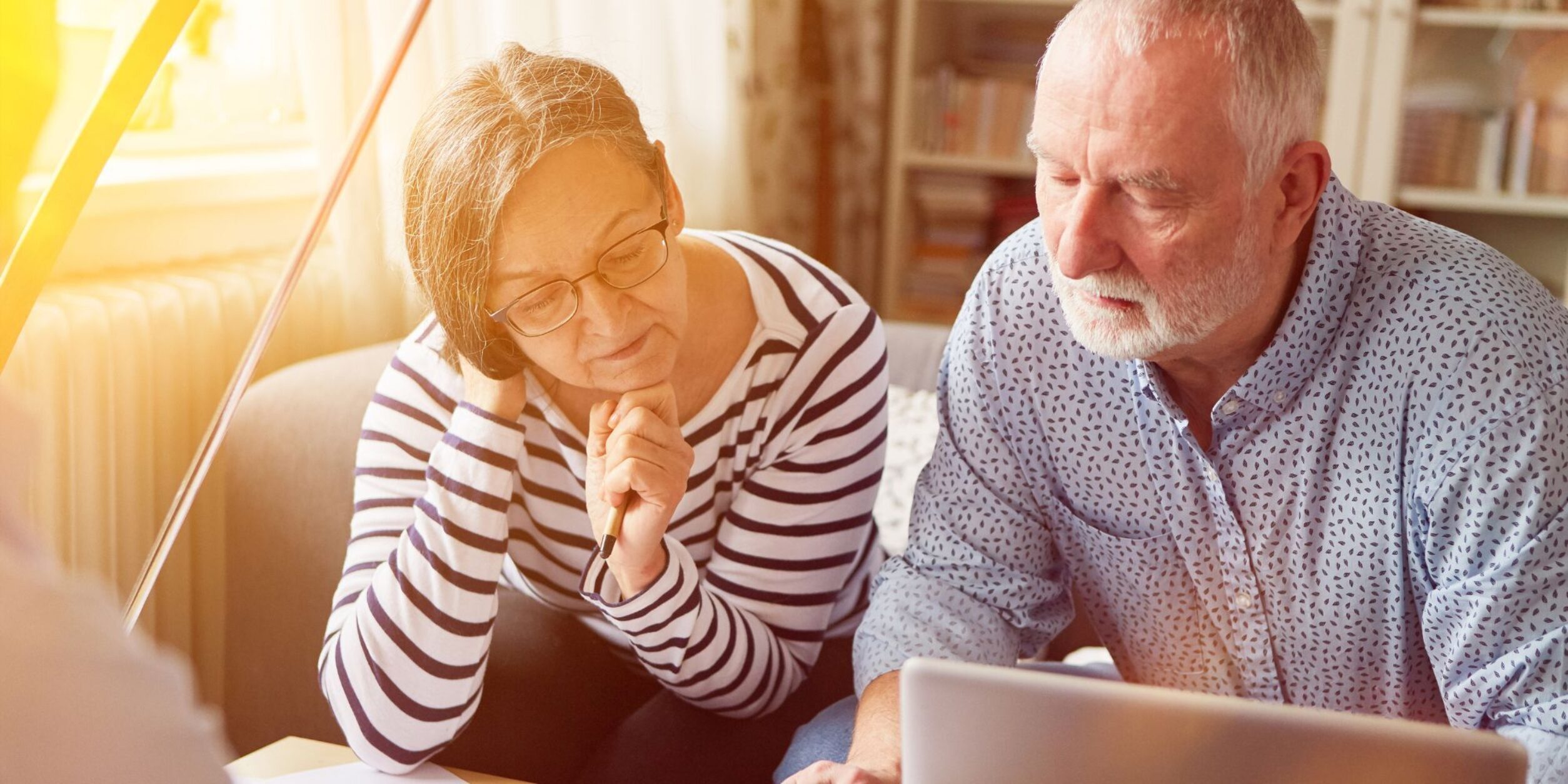 Zwei Personen kurz vor der Rente schauen zusammen auf Unterlagen