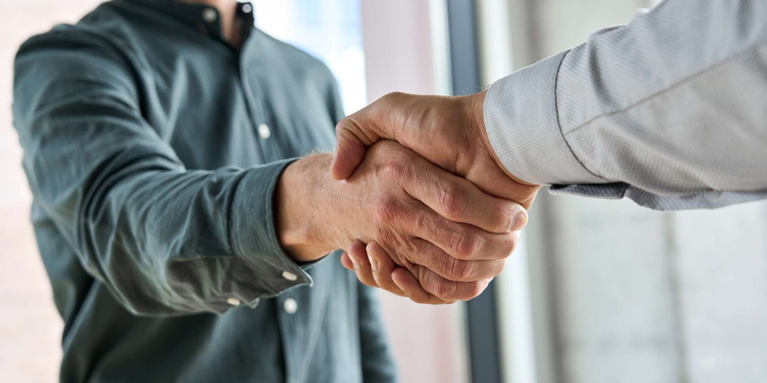 2 Personen schütteln die Hände