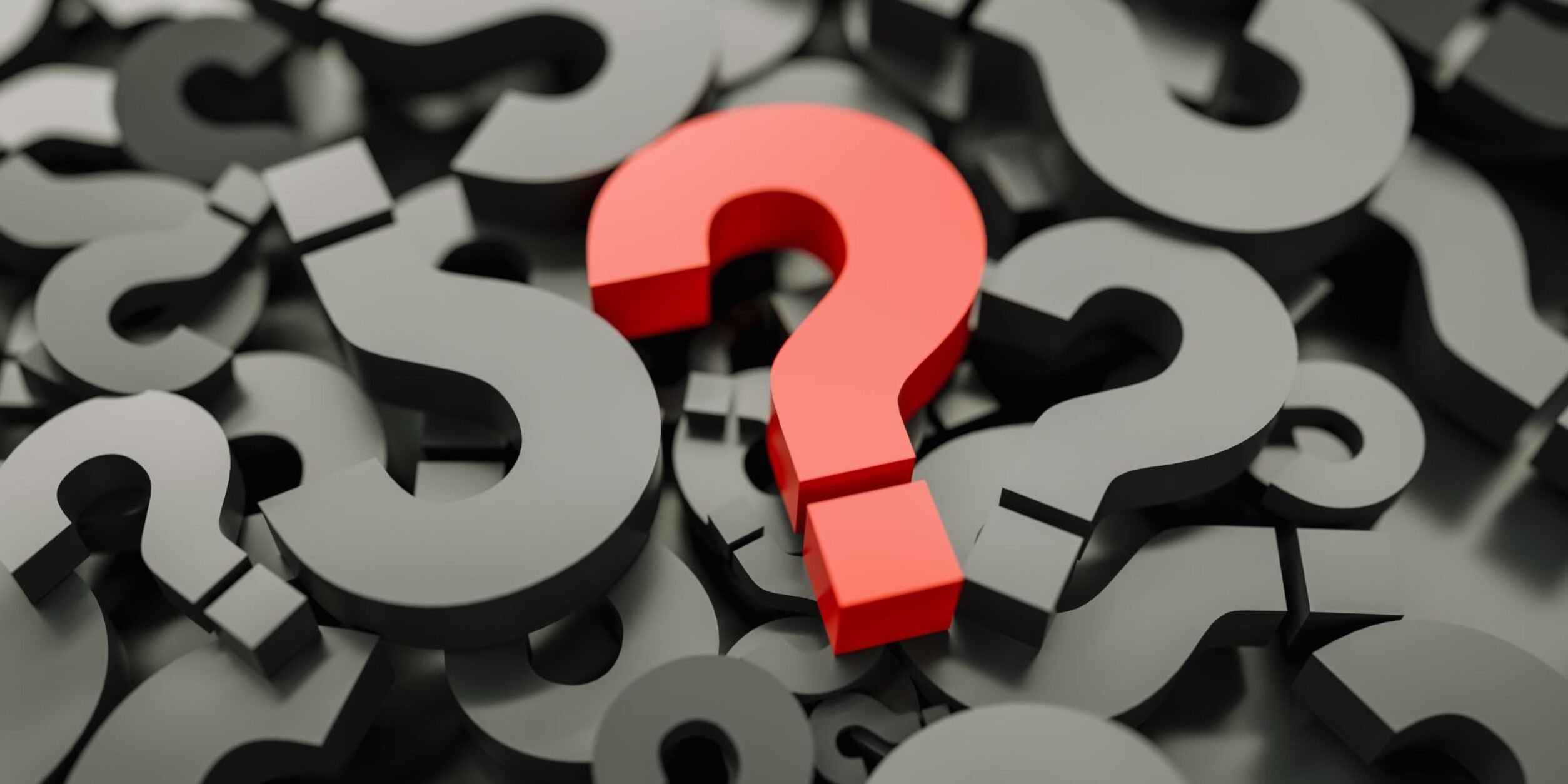Ein rotes Fragezeichen inmitten vieler schwarzer Fragezeichen