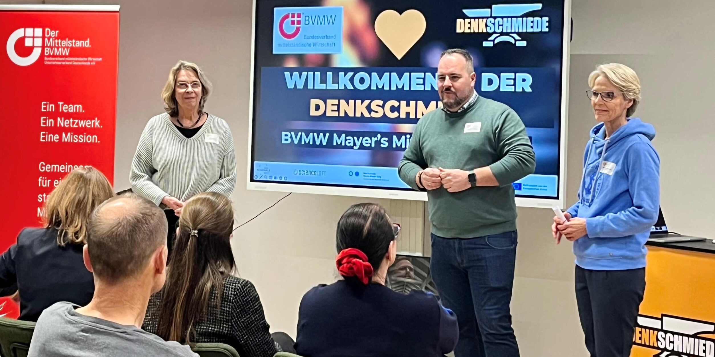 Julian Mayer mit Referenten bei der Begrüßung