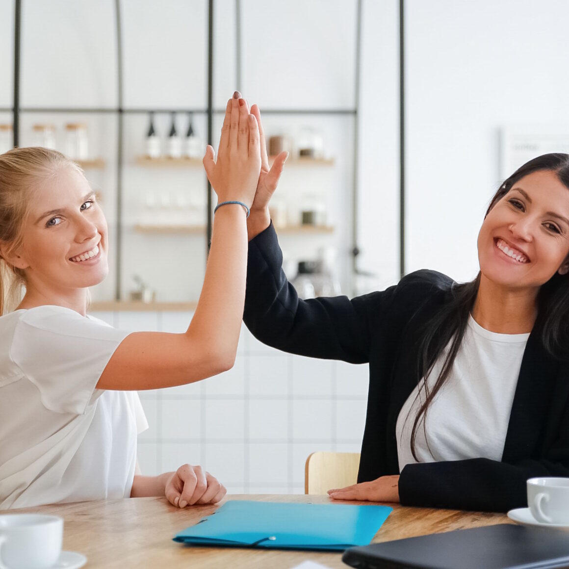 Happy young business women giving high five celebration