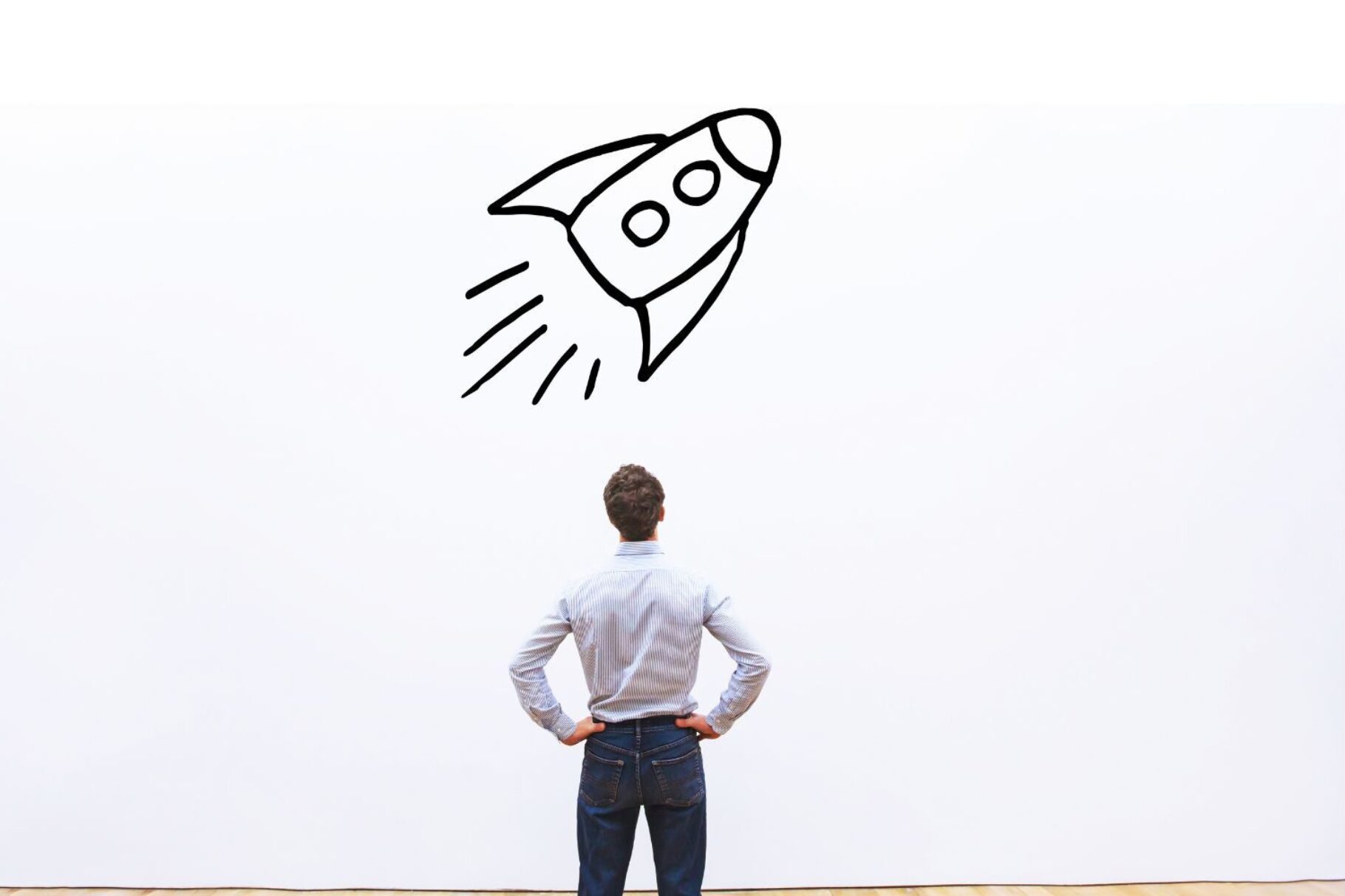 Comic-Rakete hebt ab, Mann in weißem Hemd steht davor und sieht ihr dabei zu