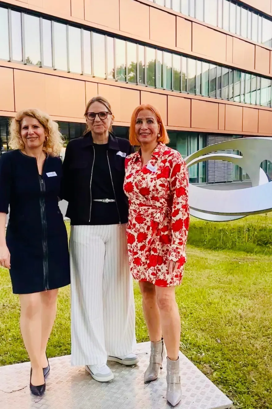 Margit Schmitz mit zwei Teilnehmern vor Gebäude